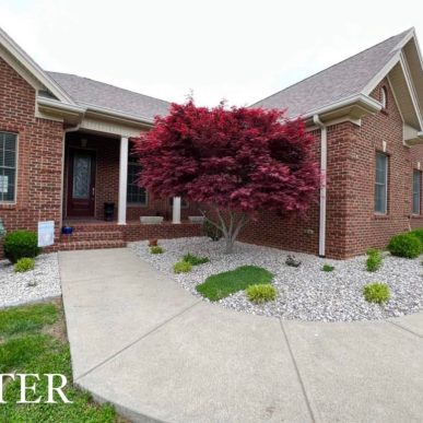 Residential walkway landscaping with river rock and plants in Saint Charles Missouri