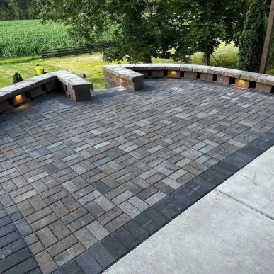 Backyard patio with outdoor lighting and seating at a Lake Saint Louis home