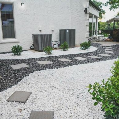 Stone walkway landscaping installed along house foundation in Saint Charles MO
